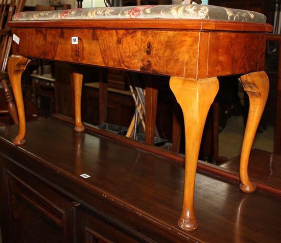 A walnut duet piano stool